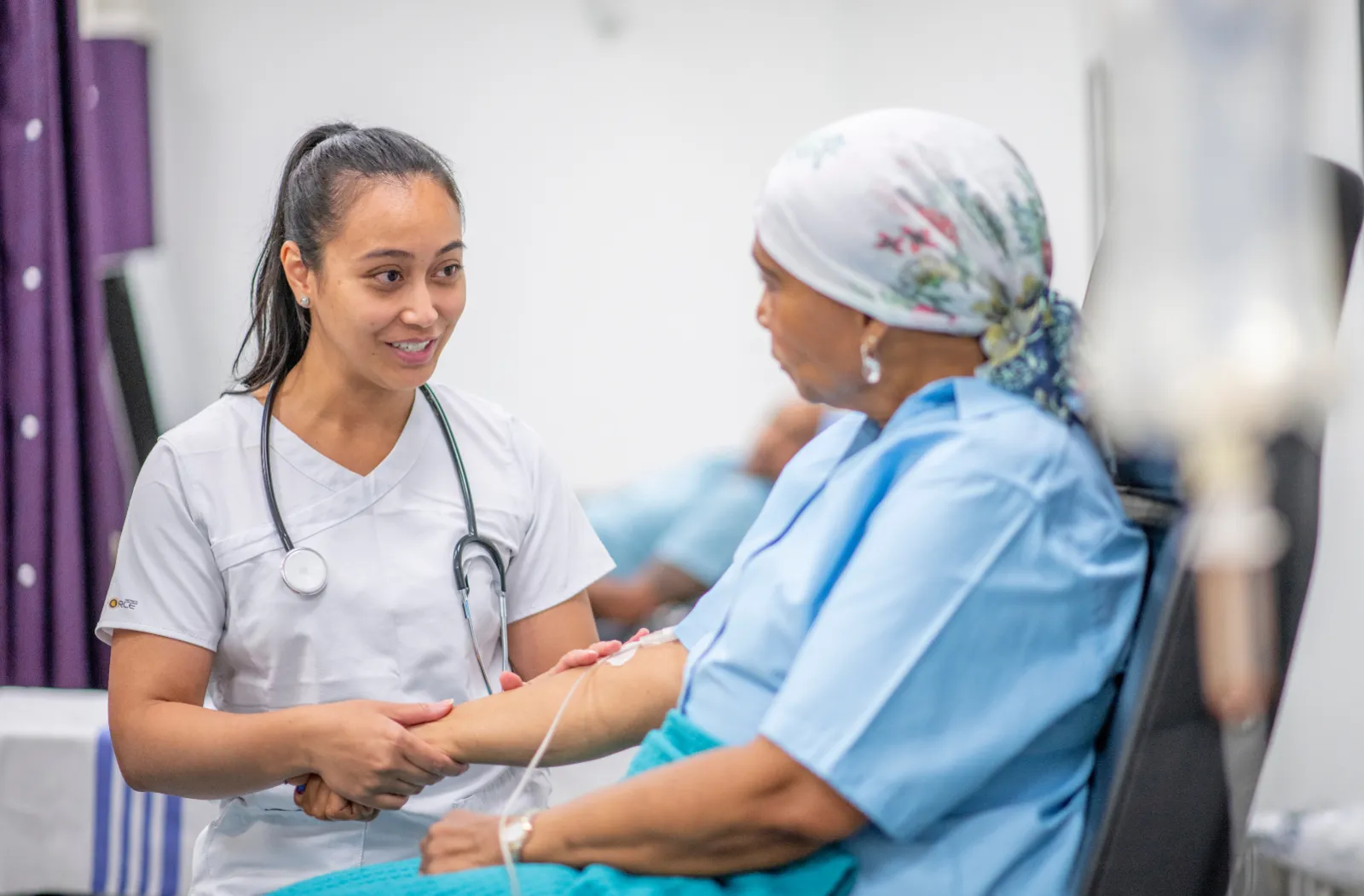 two women looking at each other, one is a doctor one is a patient