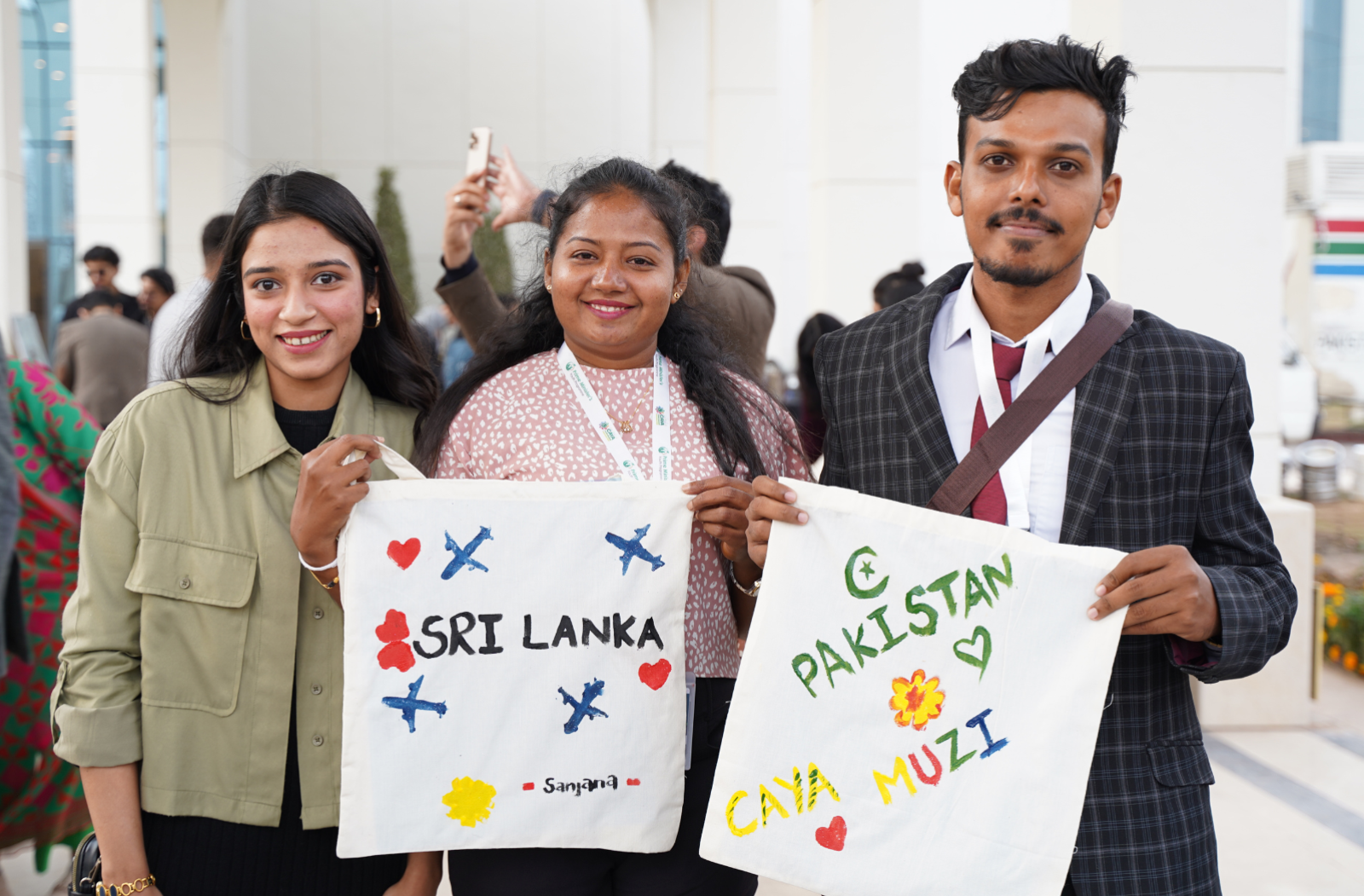 Three ������ hold up handmade signs that say Sri Lanka and Pakistan at the Commonwealth Asia Youth Alliance (CAYA) Summit