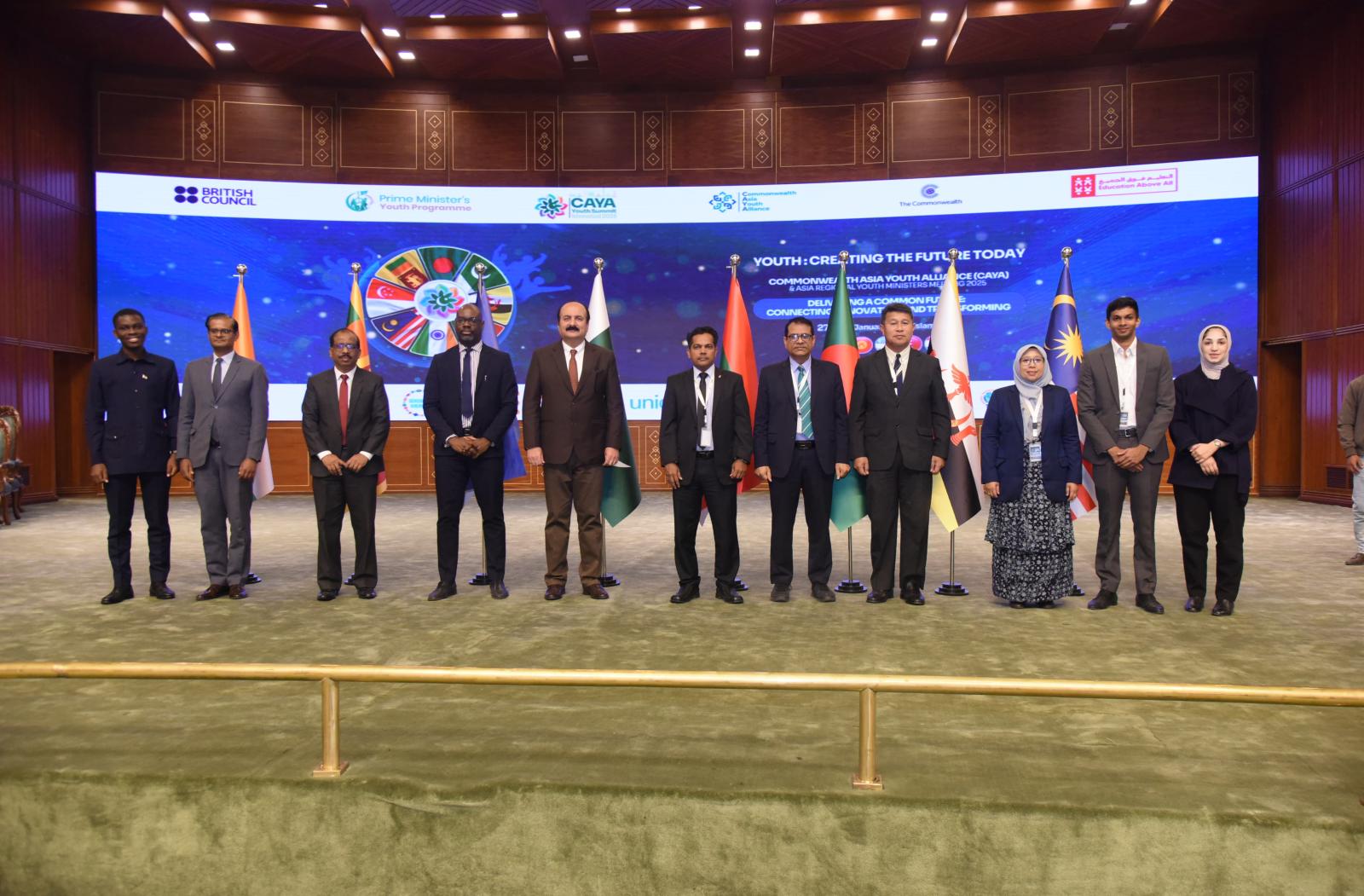 11 people standing on a stage