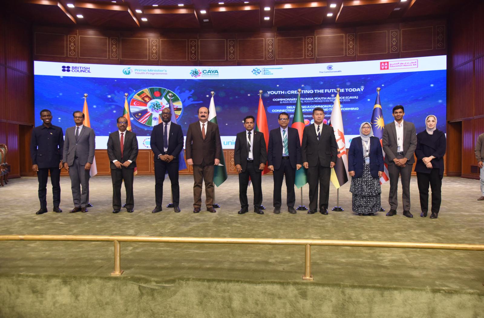 11 people standing on a stage