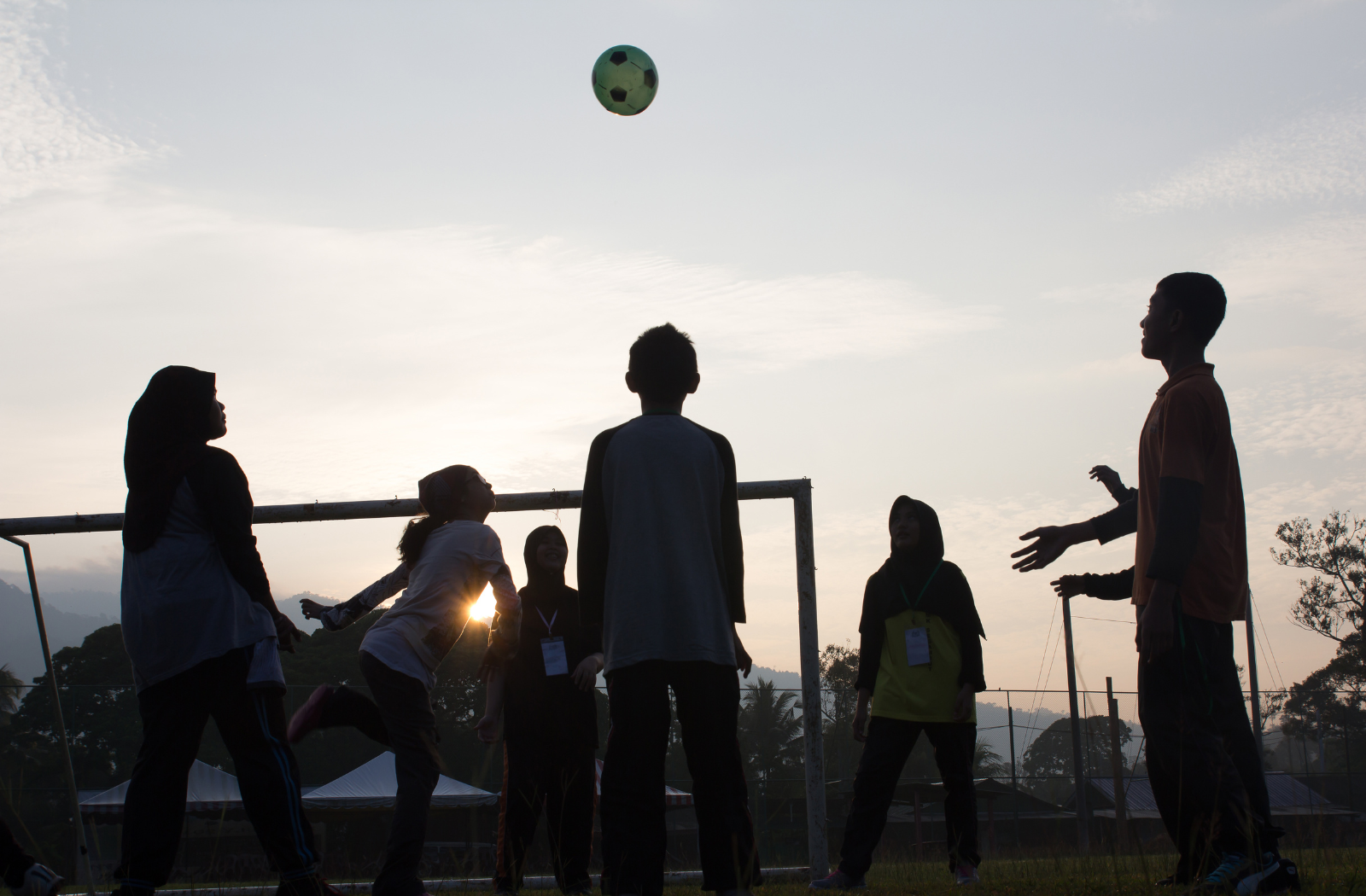 Young people playing with football 