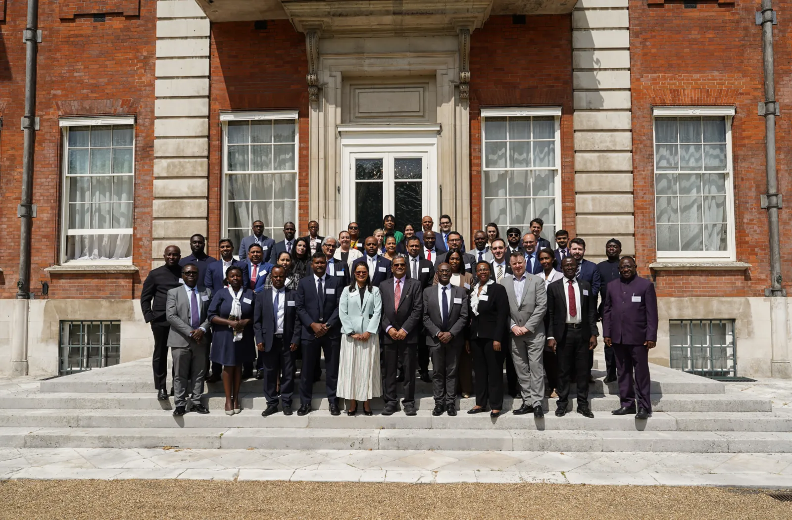 Group photo of delegates at the 4th Commonwealth Sustainable Energy Forum on the stairs of Marlborough House
