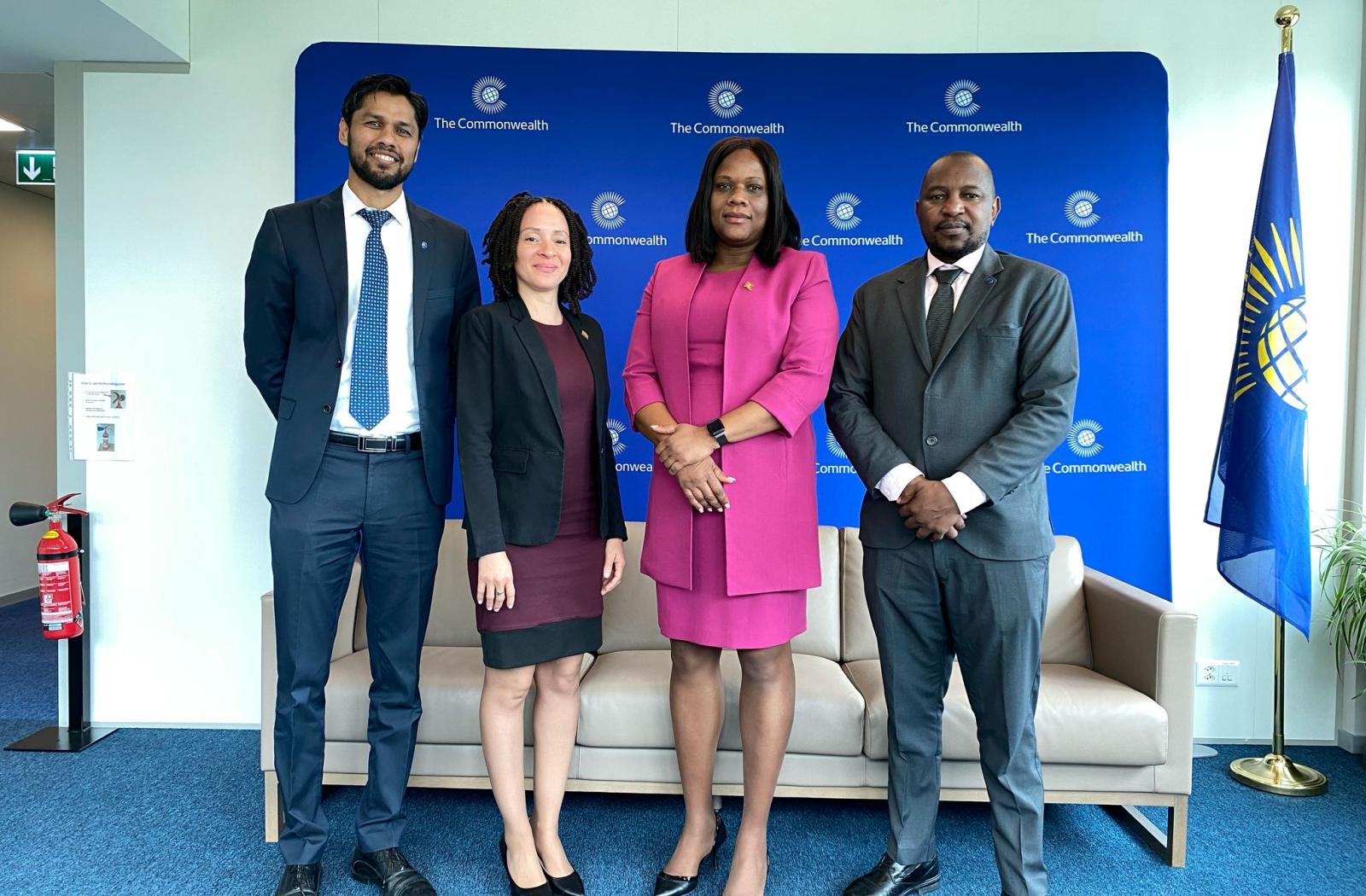 four people standing posing for a photo