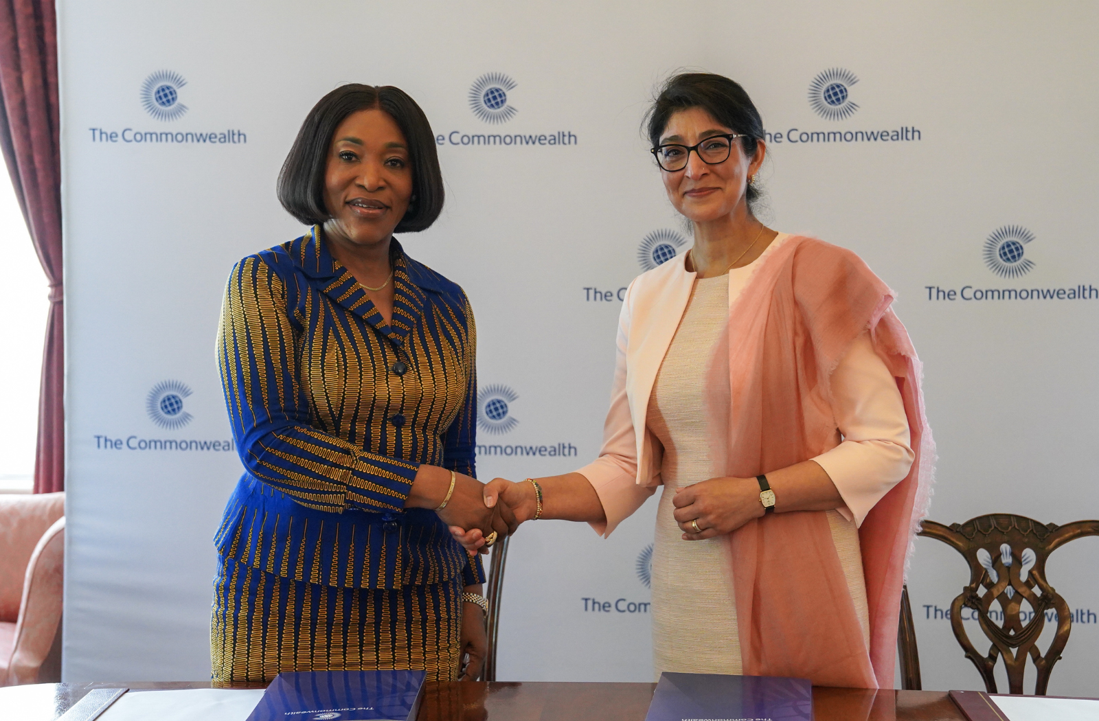 Commonwealth Secretary-General and UNOOSA Director shake hands after signing the MoU