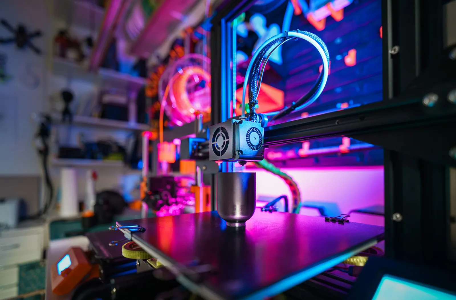 A 3D printer with a printed object on the worktop, in a home workshop. Photographer: Jakub Żerdzicki