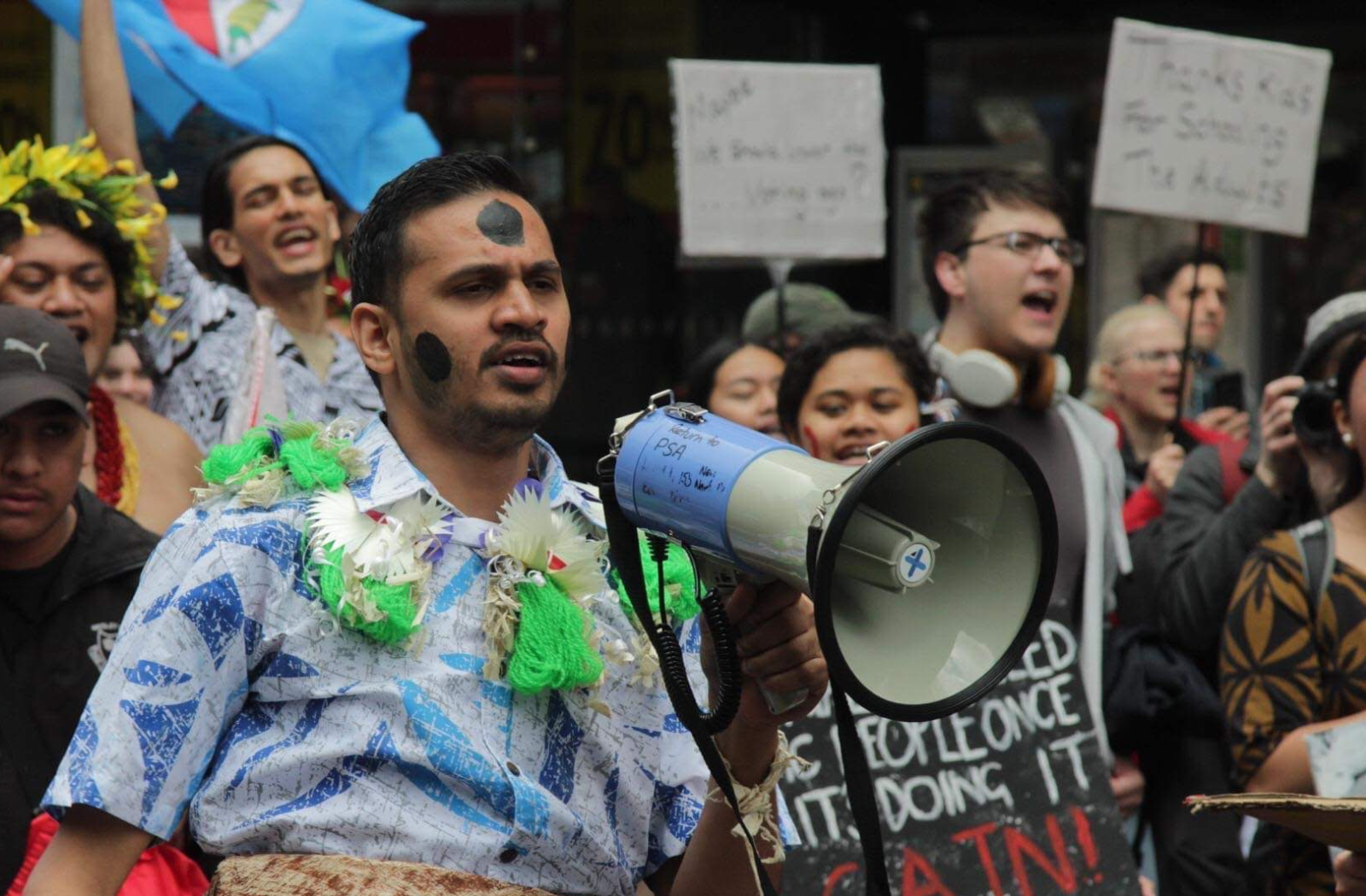 A young activist with a megaphone at a climate protest
