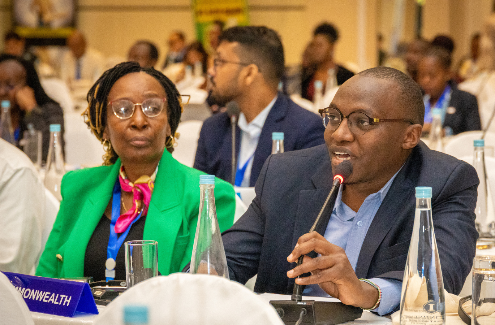A man speaks into a microphone at an event