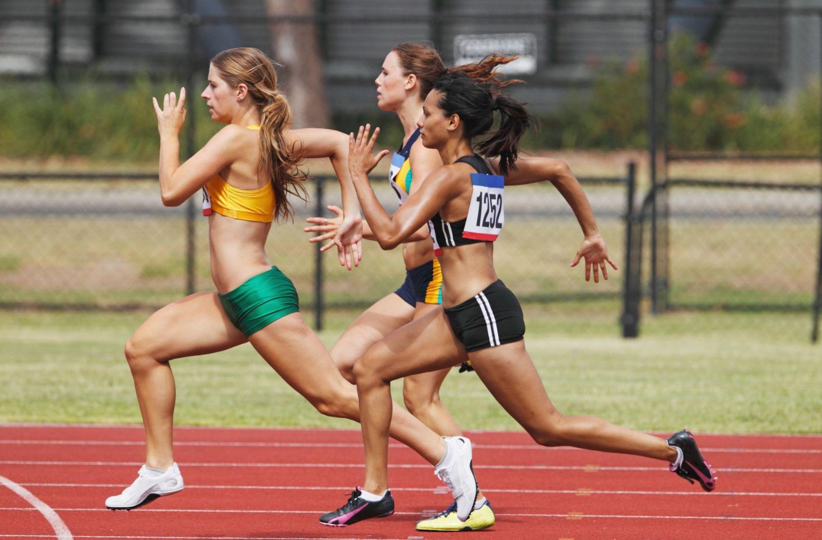 Three female athletes on a race track