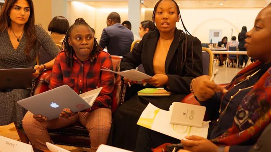 four young people talking in a group