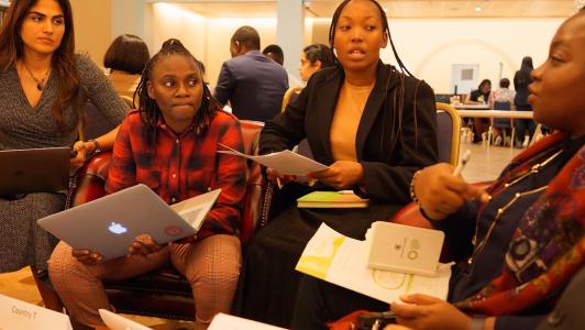 four young people talking in a group 