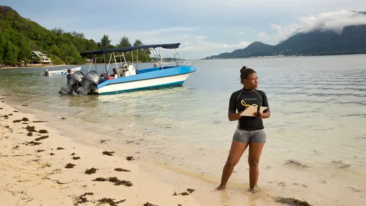 A woman maps coral reefs around Mahe Island in Seychelles