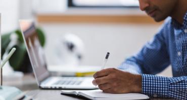 Man writing in notebook