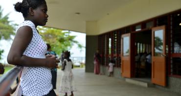 A girl waits for the end of a church service in Solomon Islands 