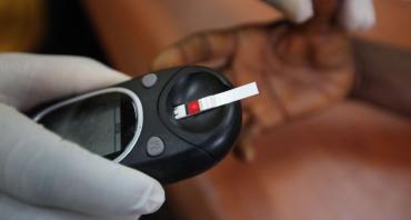 A doctor taking a blood sample from a patient