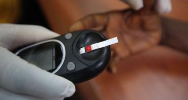 A doctor taking a blood sample from a patient