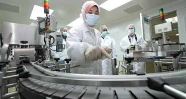 Medical professionals in masks looking at equipment