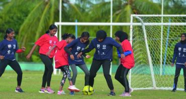 Girls playing football in the Maldives