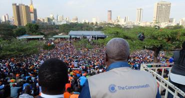 COG members looking over a crowd of people in Kenya