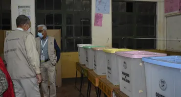 COG members looking at ballot boxs