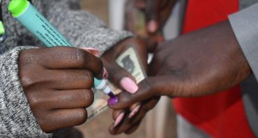 Person getting their finger marked for voting