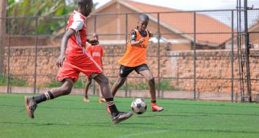 Two boys playing football