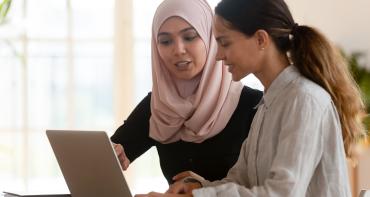 Two woman working on laptop