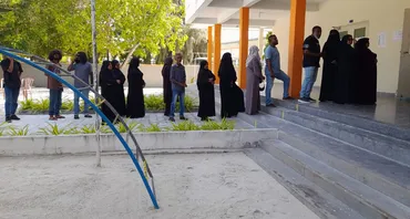 People in the Maldives wait to cast their vote at a polling station