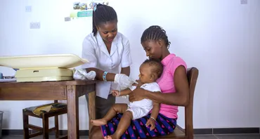 A health worker performs a rapid diagnostic test for malaria on a child (MNMUK)