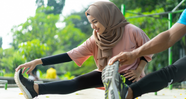 Two people stretching before exercise