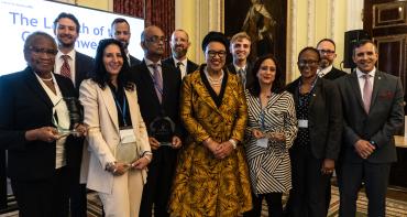 lawyers and award winners gather around SG for a photo 