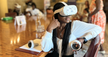 woman wears virtual reality headset to experience the Commonwealth Youth virtual museum