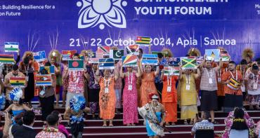 Commonwealth Youth Forum at CHOGM 2024 flags on stage