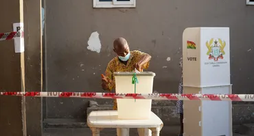Man putting vote into ballot box