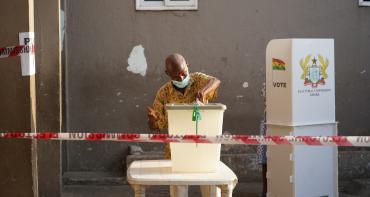 Man putting vote into ballot box
