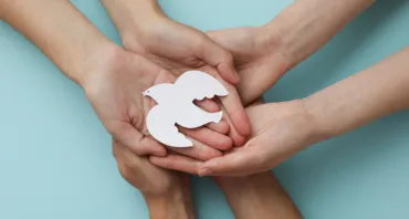 People hold dove in hands