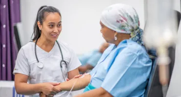 two women looking at each other, one is a doctor one is a patient