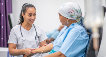 two women looking at each other, one is a doctor one is a patient