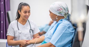 two women looking at each other, one is a doctor one is a patient