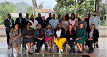 People standing and sitting in a group picture