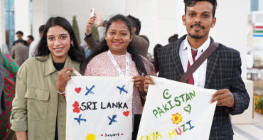 Three young people hold up handmade signs that say Sri Lanka and Pakistan at the Commonwealth Asia Youth Alliance (CAYA) Summit