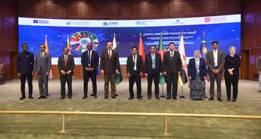 11 people standing on a stage