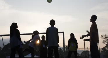 Young people playing with football 