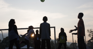 Young people playing with football 