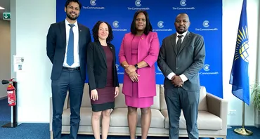 four people standing posing for a photo