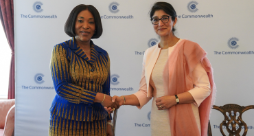 Commonwealth Secretary-General and UNOOSA Director shake hands after signing the MoU