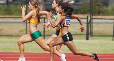 Three female athletes on a race track