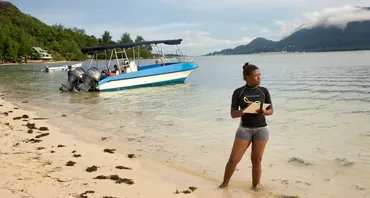 A woman maps coral reefs around Mahe Island in Seychelles