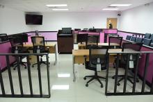 A bright, modern and informal courtroom with a pink and white two-tone wall